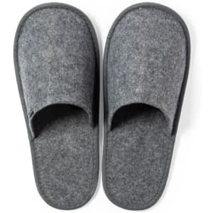 Grey felt slippers with open toes, featuring a soft upper and a black sole, showcasing a logo.
