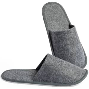 A pair of grey felt slippers with a simple design and a logo on the side. They feature a soft interior and a flat sole.