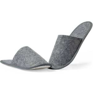 A pair of grey felt slippers featuring a simple design and soft lining. The slippers have a logo on one side.