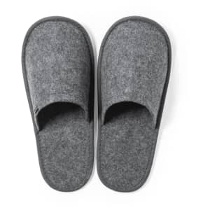 A pair of grey slippers made of felt material with an open toe design. Features a logo on the side.
