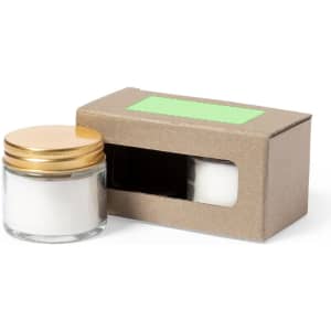 A candle set featuring a glass jar with a gold lid and packaged in a brown cardboard box.