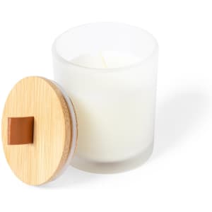 A white aromatic candle in a frosted glass container with a bamboo lid.