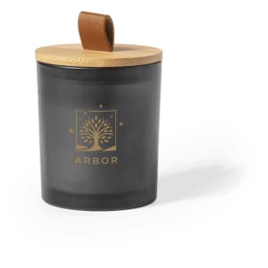 A black aromatic candle in a glass jar, featuring a bamboo lid and a leather strap. It has a logo on the front.