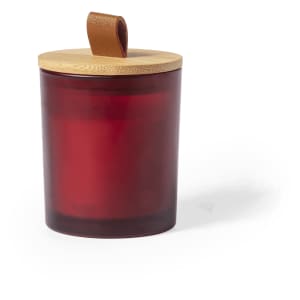 A red aromatic candle in a glass jar, topped with a bamboo lid and a leather strap.
