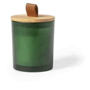 A green aromatic candle in a glass container with a wooden lid and a leather strap.