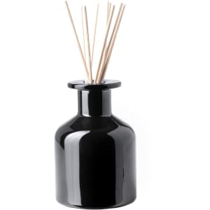 A black ceramic aromatic diffuser with reed sticks protruding from the top, featuring a sleek, glossy finish.