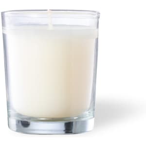 A glass candle in a clear holder, featuring a white wax interior and a single wick.
