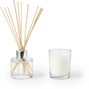 A clear glass diffuser with reeds and a white candle in a glass holder. Both items are elegantly simple in design.