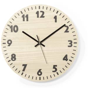 A round wooden wall clock featuring large black numbers and hands in a light wood finish.