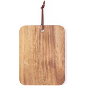 A wooden chopping board with a rectangular shape and a leather loop for hanging. The surface features a natural finish.