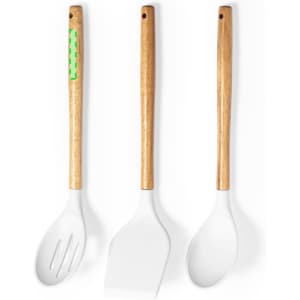 A set of three kitchen utensils with wooden handles and white silicone heads, featuring a green design on one handle.