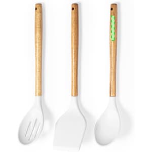 Three kitchen utensils with wooden handles and white silicone heads, featuring one with a green accent.