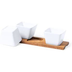 Three white serving dishes positioned on a wooden tray. The dishes are square-shaped with a sleek design.