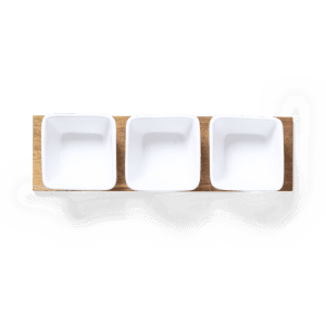 Three square white serving dishes arranged on a wooden tray, featuring a natural finish.
