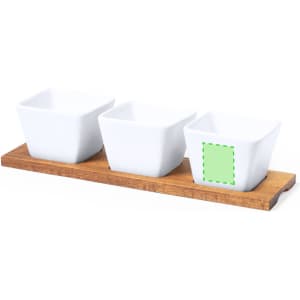 A wooden serving tray featuring three white square dishes. The tray has a natural wood finish.