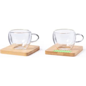A set of two clear glass mugs on bamboo coasters, featuring a modern design and a simple, elegant shape.