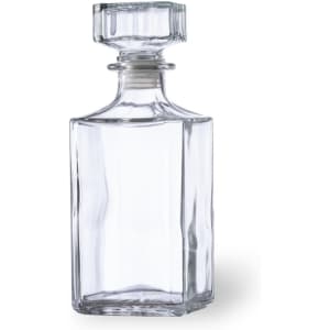 A clear glass whisky decanter with an octagonal shape and a flat top. It has a minimalist design and a sealed stopper.