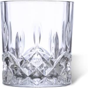A clear crystal whisky glass with intricate cut patterns on the base and sides. Features a decorative design.