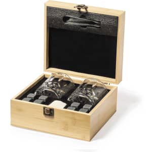 A wooden box containing two whisky glasses and whisky stones, with a sleek black interior.