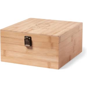A bamboo storage box with a metal clasp, featuring a logo on the lid. It is natural in colour.