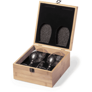 A wooden box containing two wine glasses, resting on a soft black interior lining. The exterior is light bamboo.
