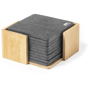 A stack of grey coasters displayed in a bamboo holder, featuring a logo on one coaster.