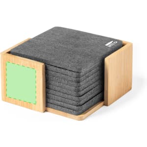 A wooden holder contains a set of grey coasters, neatly stacked inside. The holder features a green square section.