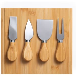 A bamboo cheese board with four stainless steel knives featuring wooden handles.