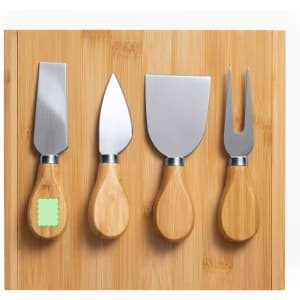 A bamboo cheese board featuring four stainless steel cheese knives with wooden handles.