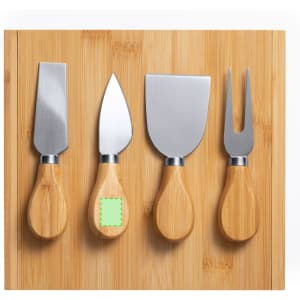 A bamboo cheese board featuring four stainless steel cheese knives with wooden handles.