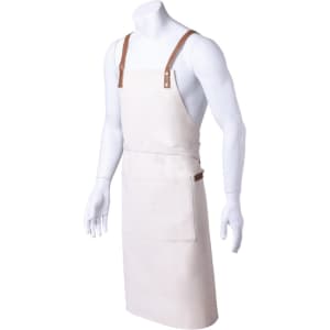 A beige apron with brown leather straps and a front pocket, displayed on a mannequin. It features a logo.