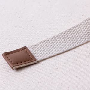 A textured light beige strap with a brown leather accent, featuring a woven design and stitched detailing.
