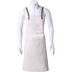 A light-coloured apron with brown straps, featuring a front pocket and a logo.