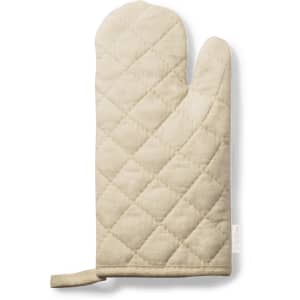 A beige kitchen mitten with a quilted pattern, featuring a hanging loop and a logo on the side.