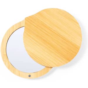 A pocket mirror with a bamboo exterior featuring a round shape and a reflective surface inside.