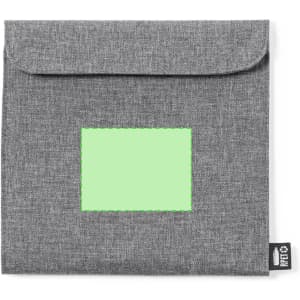 A grey lunch bag with a flap closure and a blank area for a label, featuring a branding tag.