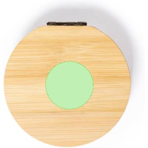 A circular, bamboo jewellery wrap with a green circular accent in the centre, featuring a metallic clasp.