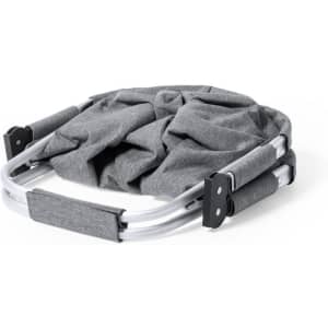 A grey fabric bag with a folding metal frame, featuring padded handles for easy carrying. It has a branded logo.
