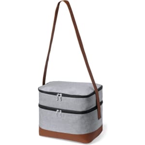 A grey cooler bag with a brown base and a shoulder strap, featuring two zippered compartments and a logo.