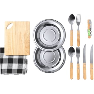 A wooden cutting board, checkered cloth, two stainless steel bowls, and cutlery with wooden handles.