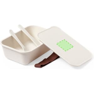 A cream-coloured lunch box with two compartments, a lid, and a brown strap. It features a logo on the lid.