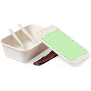 A lunch box in cream with a green cover and brown strap, featuring two compartments and utensils.