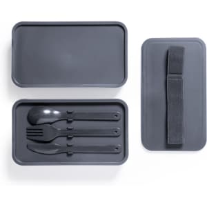 A grey lunch box with a lid, containing black cutlery (spoon, fork, knife) and a strap for fastening.