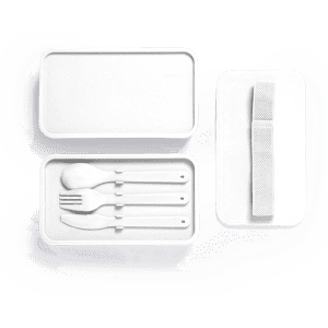 A white lunch box with three utensils (fork, spoon, knife) and a strap for securing the lid.