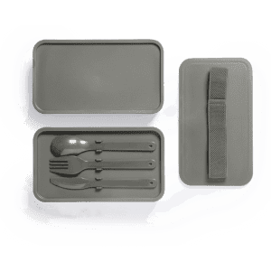 A grey lunch box with a lid, containing cutlery including a fork, knife, and spoon, along with a strap.