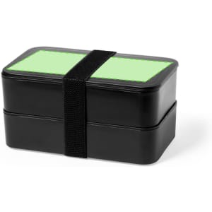A black lunch box with two stacked compartments and a green lid secured by a black strap.