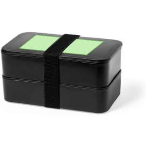 A black lunch box with a green rectangular area on top, secured with a black strap, in a two-tier design.