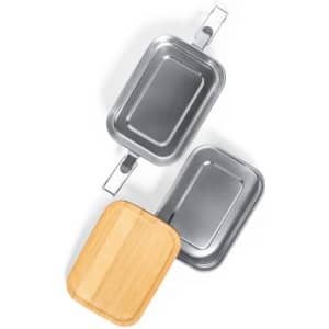 A set of three rectangular food containers, two metal and one bamboo, arranged in an overlapping position.