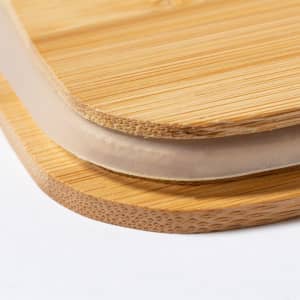 A set of bamboo lunch boxes with smooth edges, featuring a natural wood finish. They include a design with a lid.