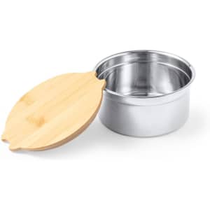 A stainless steel lunch box with a bamboo lid rests beside it. The lid features a decorative shape.